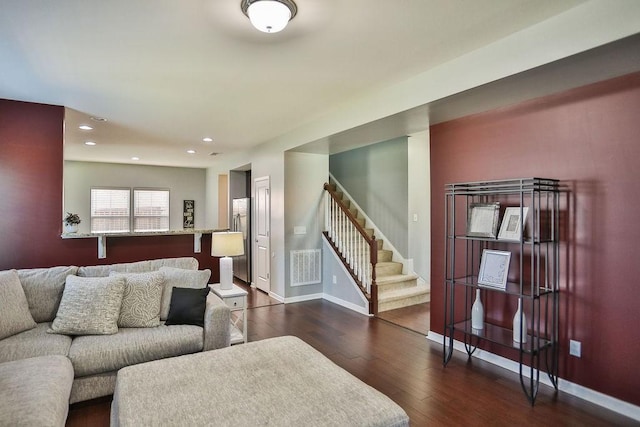 living area featuring visible vents, recessed lighting, stairway, wood finished floors, and baseboards