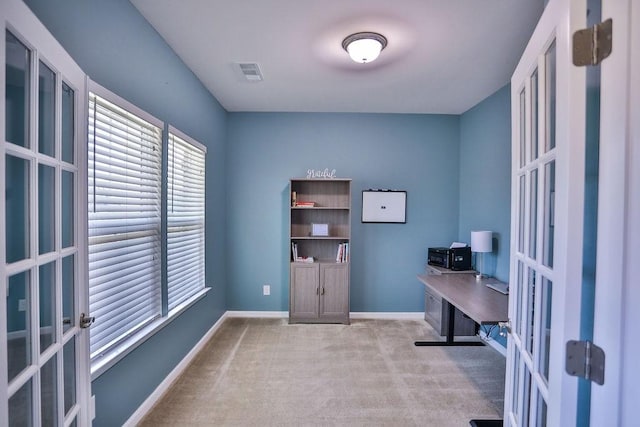 carpeted office space with french doors, baseboards, and visible vents