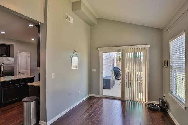 entryway with plenty of natural light, dark wood-type flooring, visible vents, and baseboards