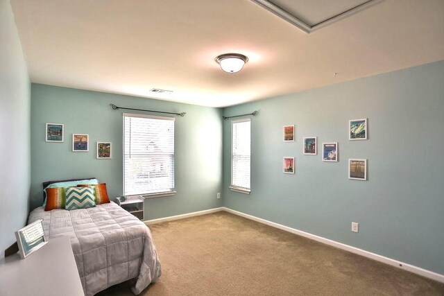 bedroom featuring visible vents, baseboards, and carpet floors