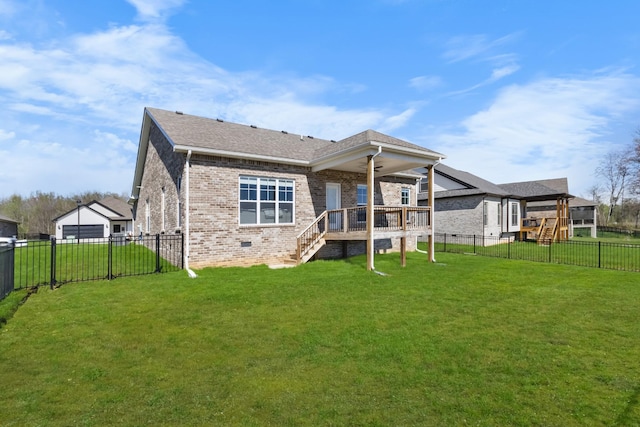 rear view of property with a yard, brick siding, a fenced backyard, and a shingled roof