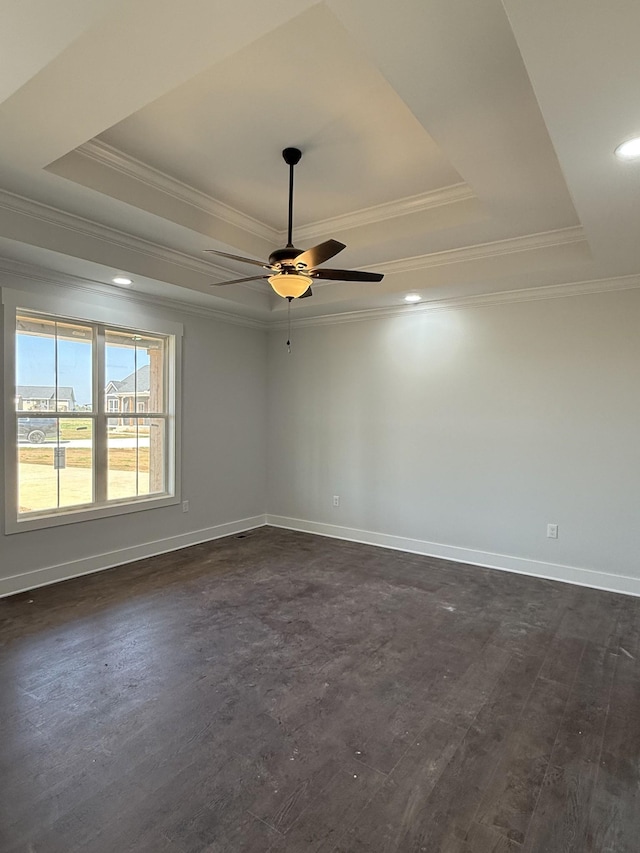 unfurnished room with crown molding, baseboards, a raised ceiling, and a ceiling fan