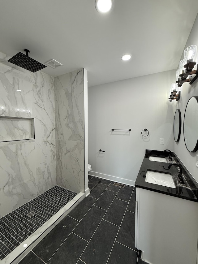 bathroom with double vanity, recessed lighting, a marble finish shower, visible vents, and a sink