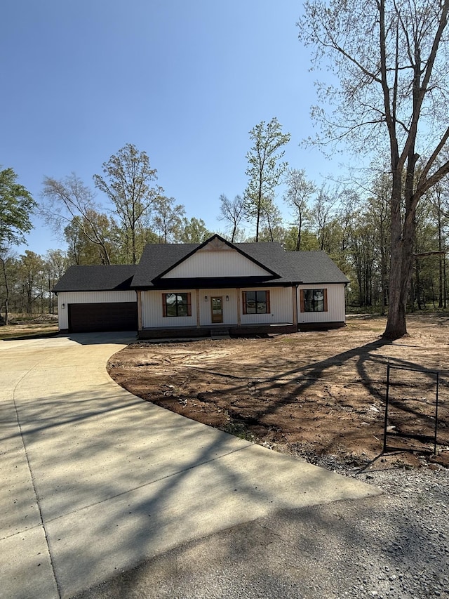 ranch-style house featuring concrete driveway and an attached garage