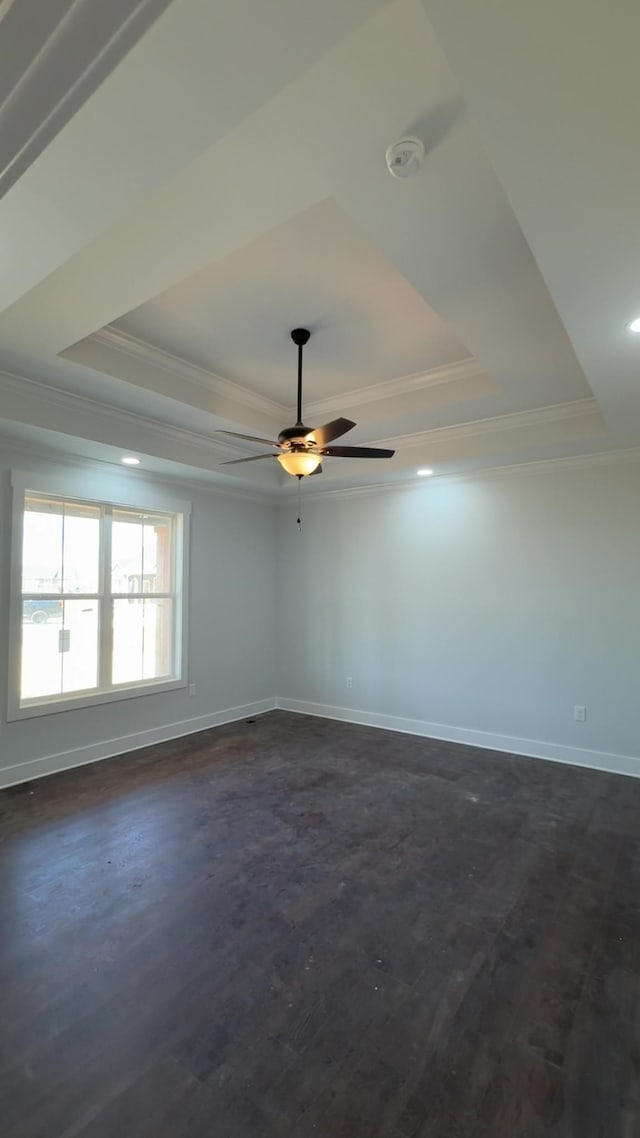 unfurnished room featuring baseboards, a tray ceiling, and ornamental molding