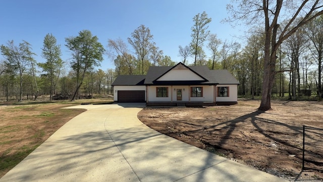 view of front of house with concrete driveway and an attached garage