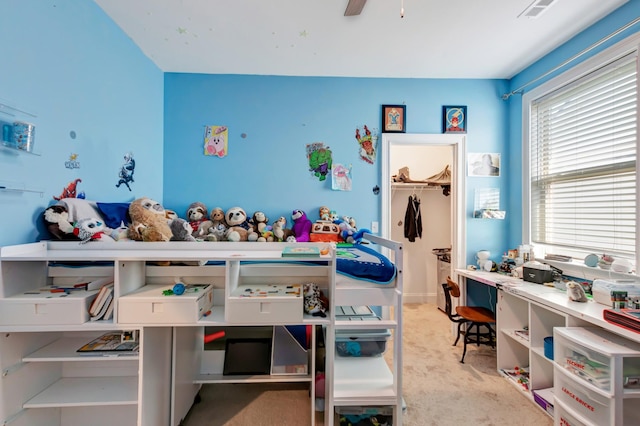 carpeted bedroom with visible vents and a ceiling fan