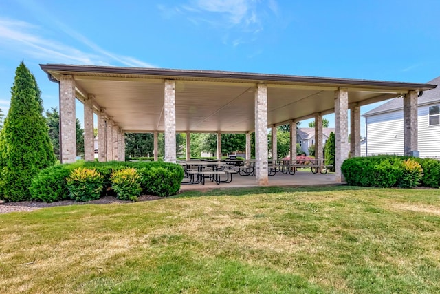 view of community featuring a patio and a lawn