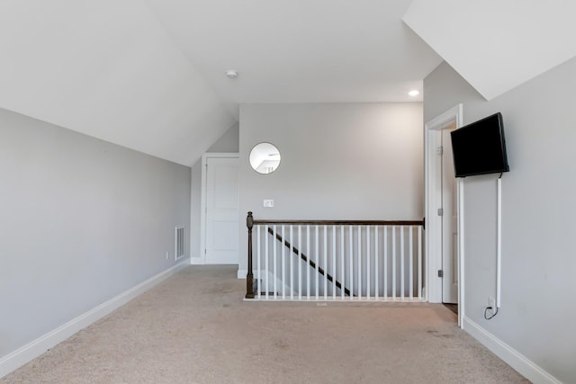additional living space with baseboards, recessed lighting, and carpet