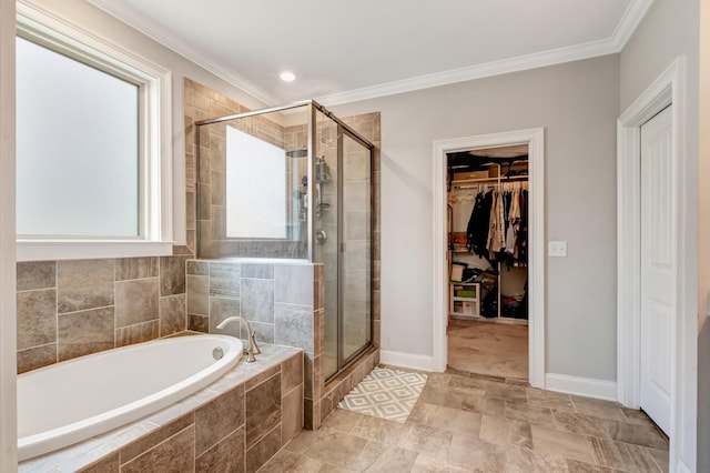 bathroom featuring a shower stall, crown molding, a garden tub, and a spacious closet