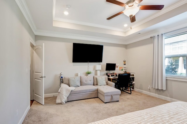 bedroom featuring ornamental molding, a raised ceiling, and light colored carpet