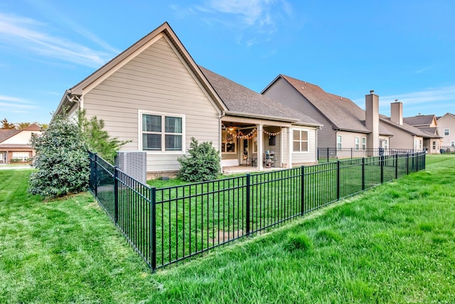 back of house with a patio, fence, and a lawn