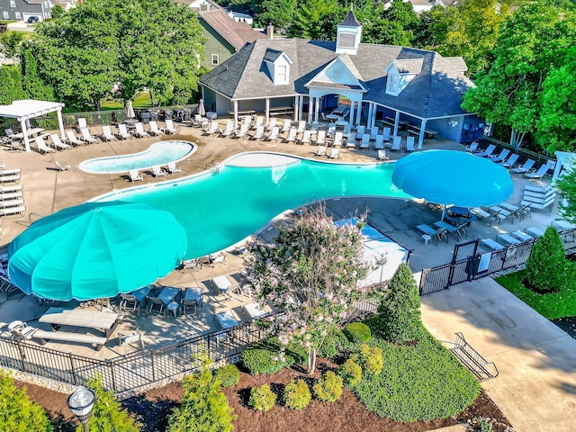 pool featuring a patio and fence