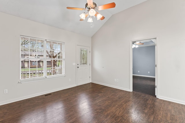 unfurnished room featuring visible vents, vaulted ceiling, a ceiling fan, and wood finished floors