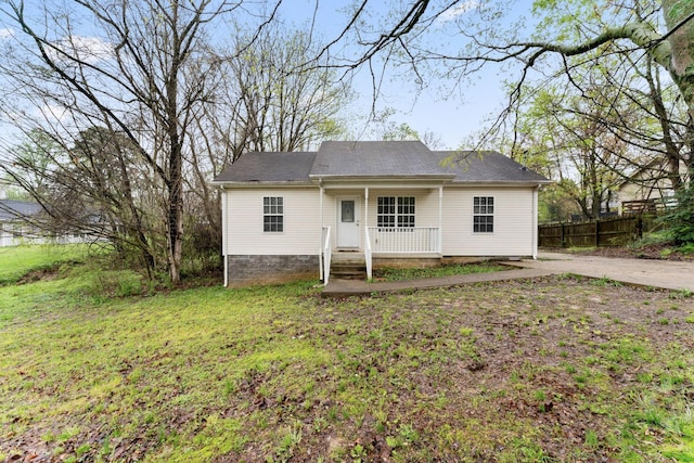 back of property featuring a yard, a porch, and fence