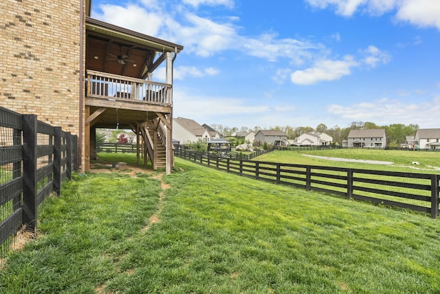 view of yard featuring a residential view, a ceiling fan, stairway, fence, and a deck