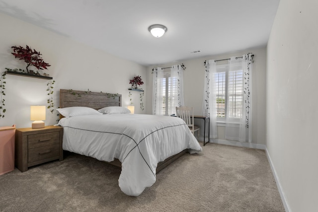 bedroom with carpet flooring, baseboards, and visible vents