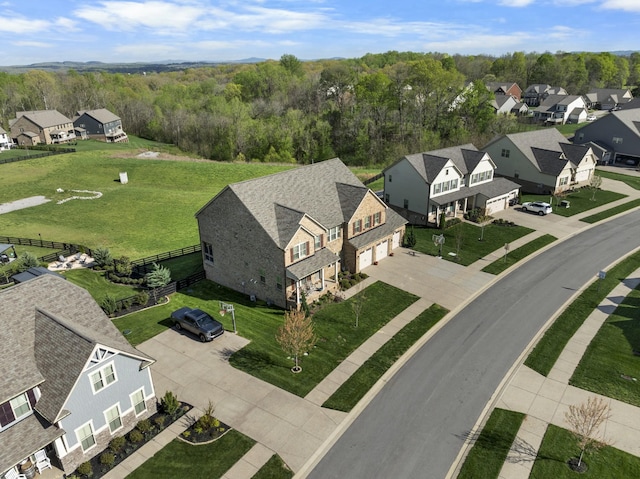 birds eye view of property with a view of trees and a residential view