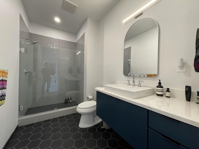 bathroom with a shower stall, vanity, visible vents, and toilet