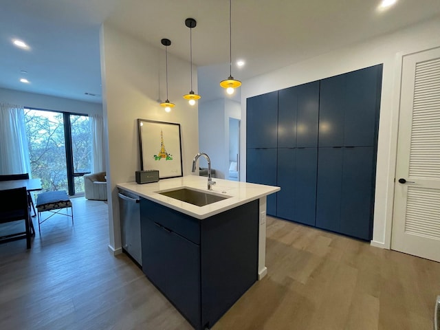 kitchen with light wood-style floors, modern cabinets, dishwasher, a sink, and hanging light fixtures