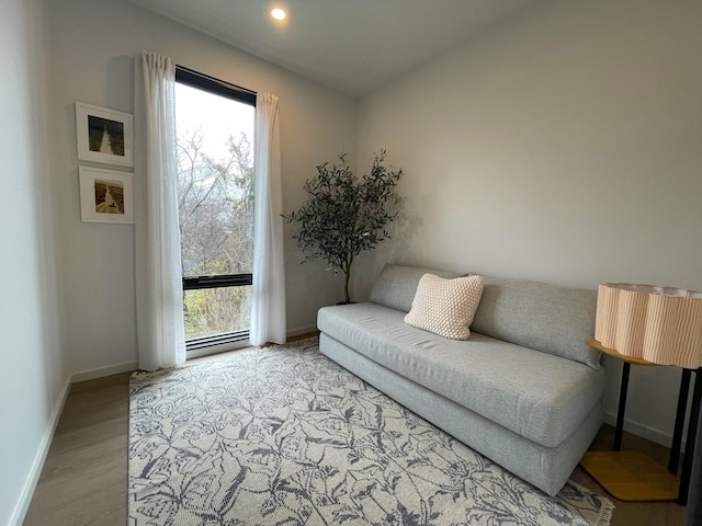 living room with recessed lighting, baseboards, and wood finished floors