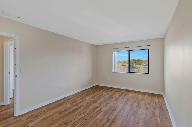 unfurnished room with wood finished floors and baseboards