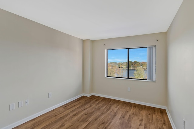 empty room featuring baseboards and wood finished floors