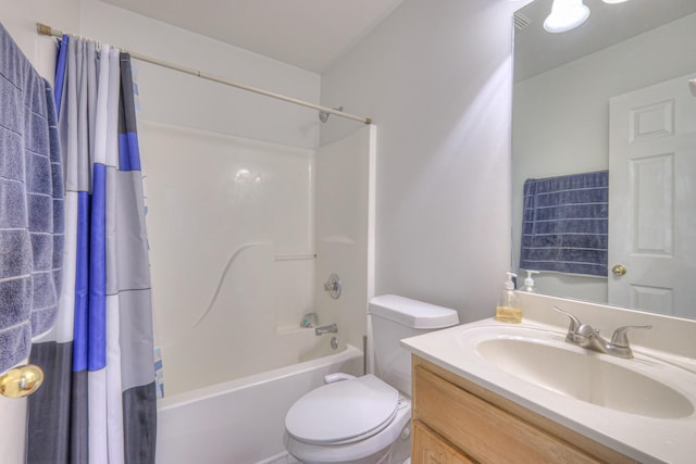 bathroom with shower / bath combo with shower curtain, vanity, and toilet