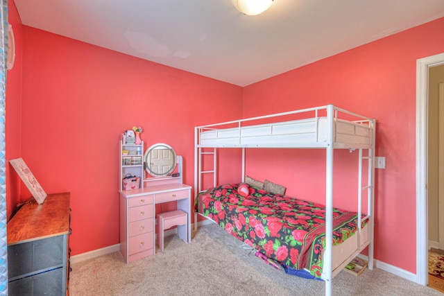 bedroom with baseboards and carpet