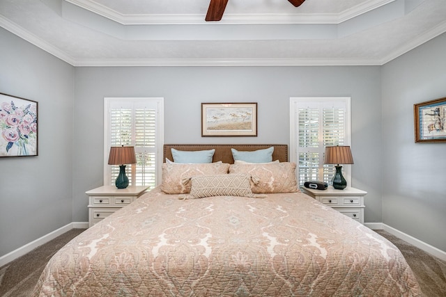 bedroom with dark carpet, baseboards, and a tray ceiling