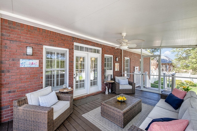 sunroom with an outdoor living space and a ceiling fan