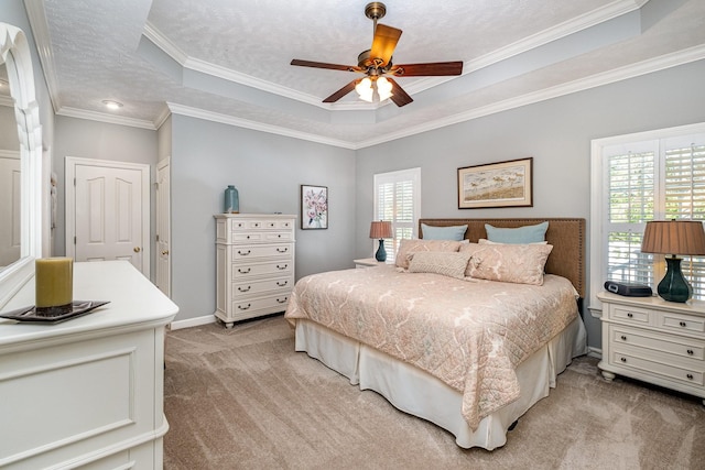 bedroom featuring light carpet, multiple windows, crown molding, and a raised ceiling
