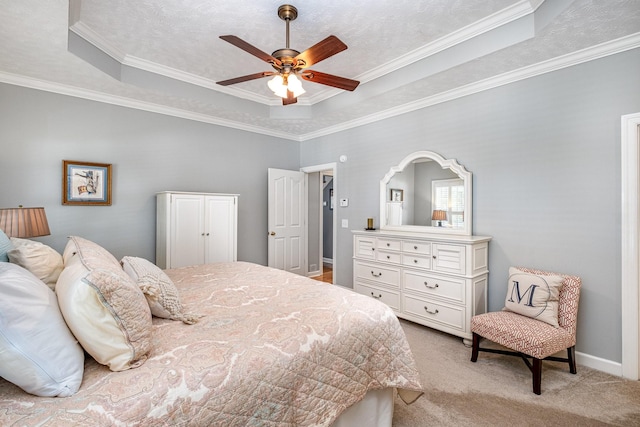 bedroom with light carpet, a tray ceiling, ornamental molding, and a ceiling fan