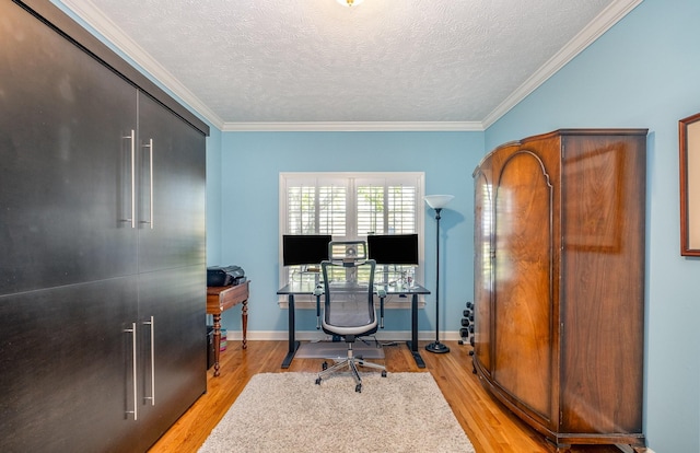 home office featuring baseboards, light wood-style floors, a textured ceiling, and crown molding