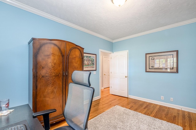 home office with crown molding, wood finished floors, baseboards, and a textured ceiling