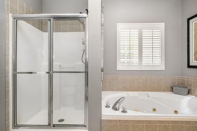 bathroom with a whirlpool tub and a shower stall