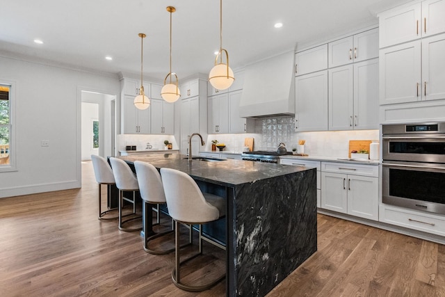 917 Kirkwood Ave, Nashville, TN 37204 - kitchen featuring range, a kitchen breakfast bar, double oven, a sink, and custom range hood