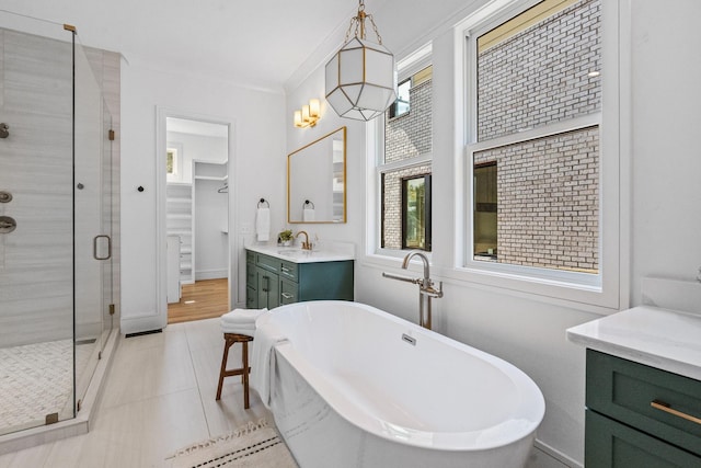 917 Kirkwood Ave, Nashville, TN 37204 - bathroom with vanity, ornamental molding, a soaking tub, a spacious closet, and a shower stall