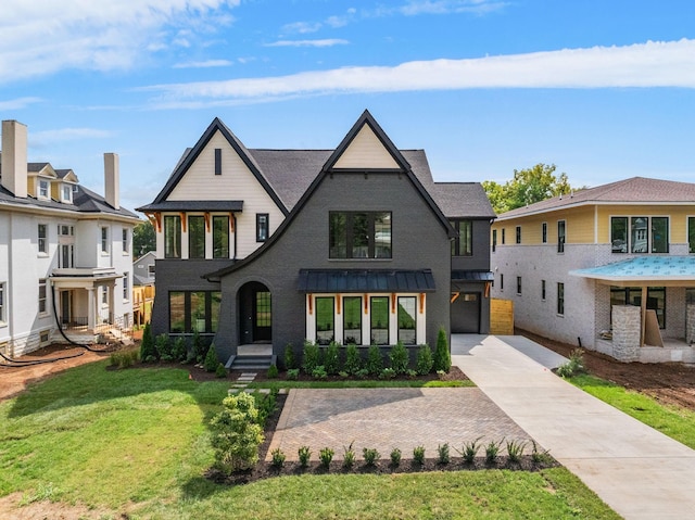917 Kirkwood Ave, Nashville, TN 37204 - view of front of property featuring a standing seam roof, a front yard, driveway, and a garage