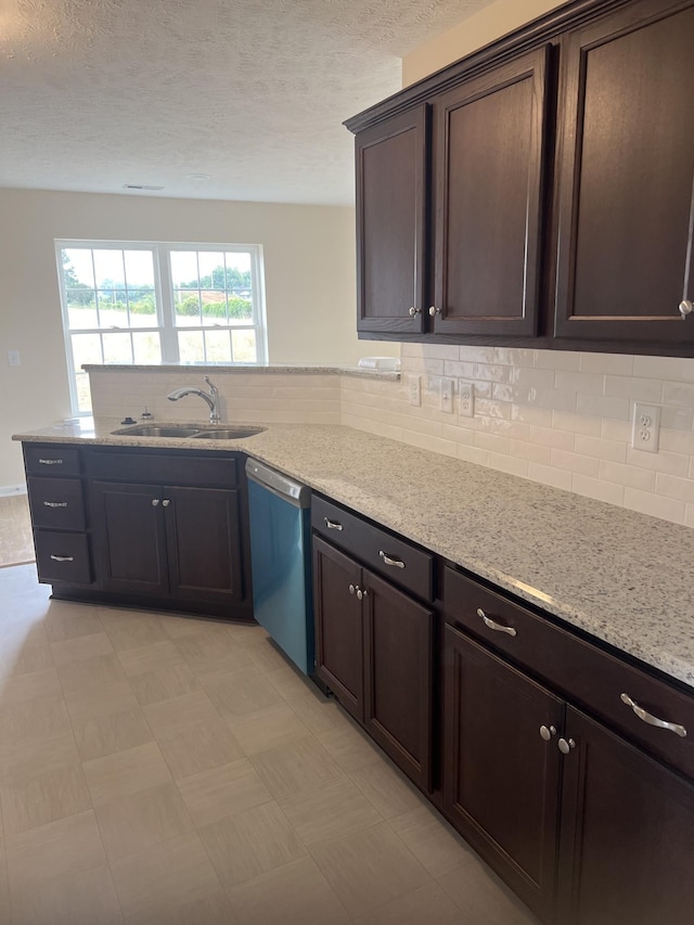 3330 Curie Cir, Christiana, TN 37037 - kitchen featuring dishwasher, dark brown cabinets, a peninsula, tasteful backsplash, and light stone counters