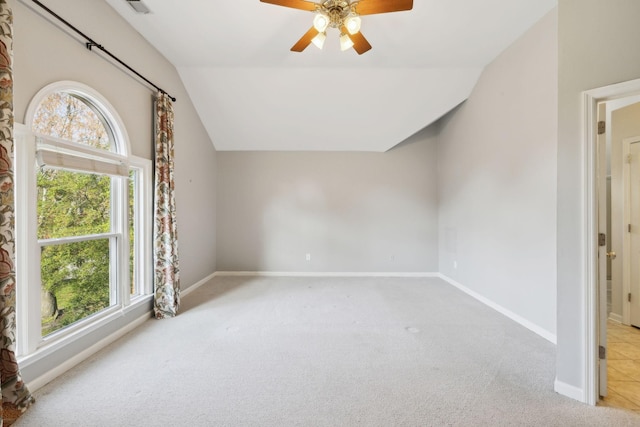 unfurnished room with ceiling fan, carpet, baseboards, and lofted ceiling