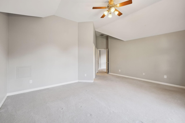 unfurnished room featuring ceiling fan, light colored carpet, baseboards, and lofted ceiling
