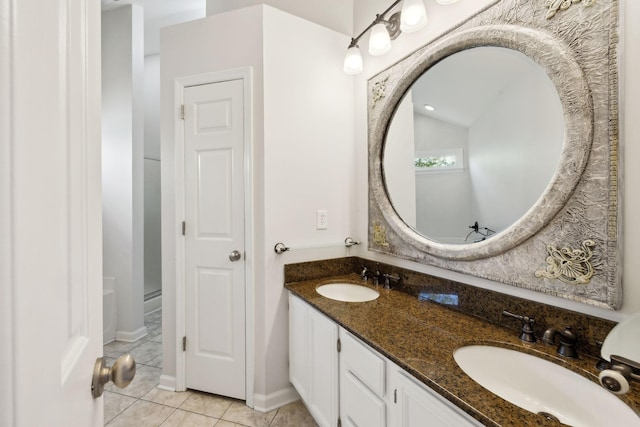 bathroom with a sink, double vanity, and tile patterned flooring