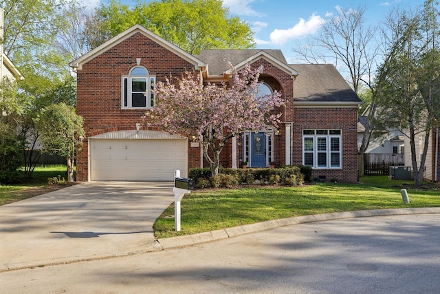 traditional-style house with driveway, an attached garage, a front lawn, brick siding, and fence