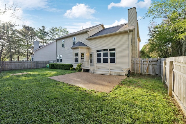 back of house with a patio, a yard, a fenced backyard, and a chimney