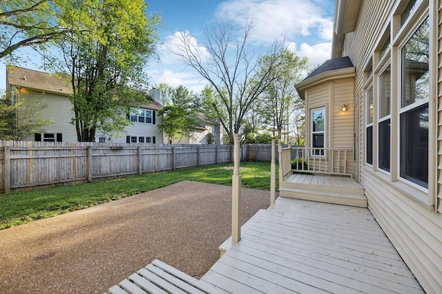deck with a yard, a fenced backyard, and a patio area