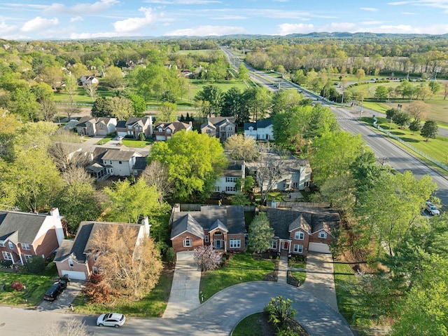 bird's eye view with a wooded view and a residential view
