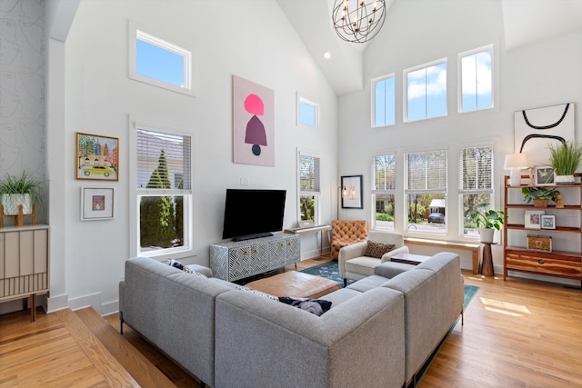 living area featuring light wood-type flooring, baseboards, a chandelier, recessed lighting, and high vaulted ceiling
