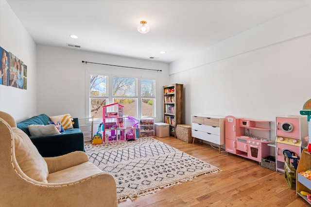 recreation room with visible vents, recessed lighting, and wood finished floors