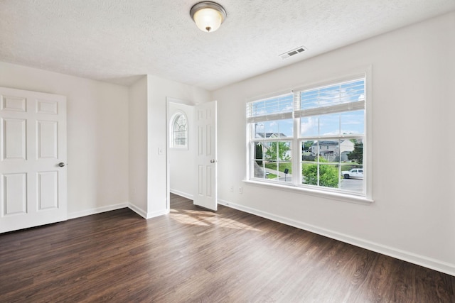 213 Nashua Ct, Murfreesboro, TN 37128 - spare room featuring a textured ceiling, visible vents, baseboards, and dark wood-style flooring